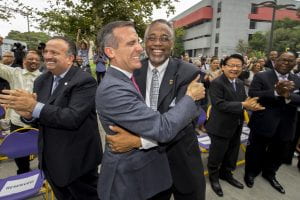 Los Angeles City Mayor Eric Garcetti, left, celebrates with LA City Councilman Curren D. Price, Jr. during the announcement of The South Los Angeles Transit Empowerment Zone or Promise Zone a federal program created by President Obama through the U.S. Department of Housing and Urban Development (HUD) with the goal of addressing challenges in geographic areas of deep and persistent poverty, Monday, June 6, 2016.(USC Photo/Gus Ruelas)